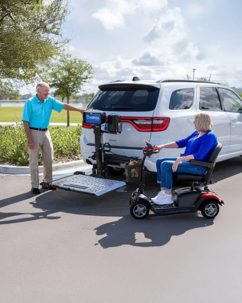 Harmar vehicle lift with scooter at the back of an SUV
